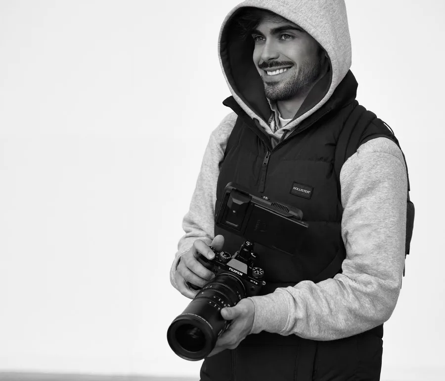 iArtist Studios photographer holding a film camera, black and white portrait