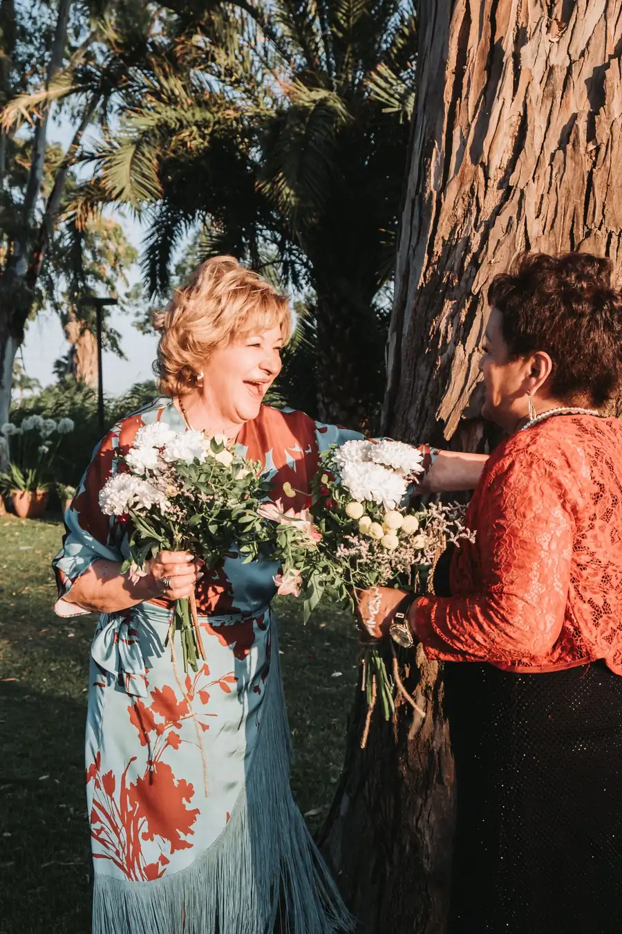 Wedding guests celebrating with flowers — destination wedding in Spain
